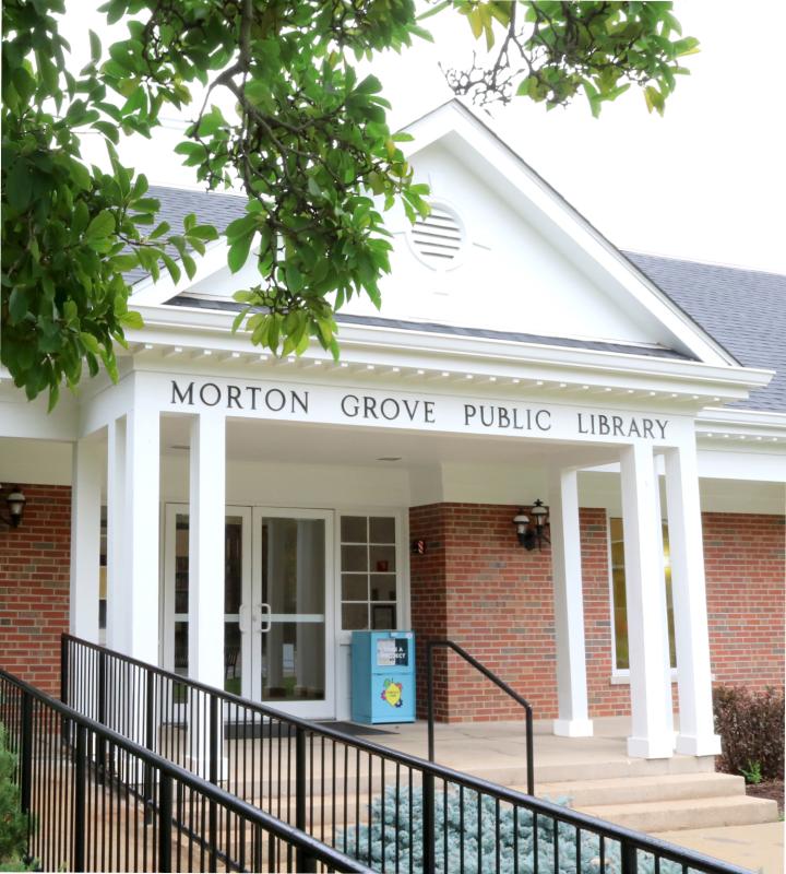 Front of the library building with white column and red brick